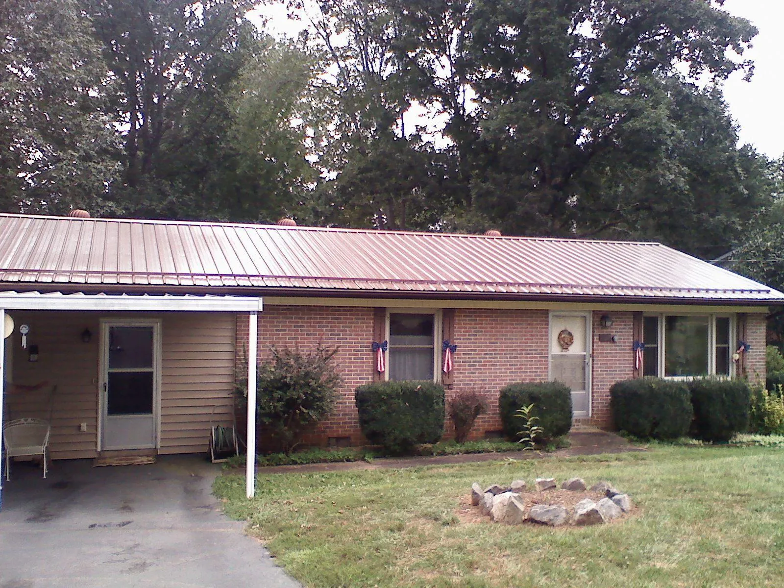 Bronze metal roof and carport on a brick ranch home — Roof Repair work by our crew in Merchantville